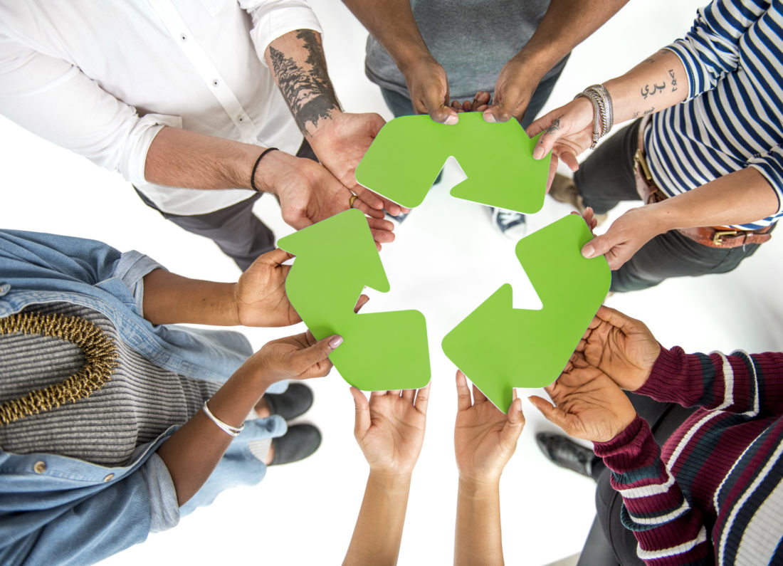 Group of People Holding Recycling Sign Concept